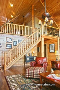 A staircase from the living room leads to the bedroom loft.