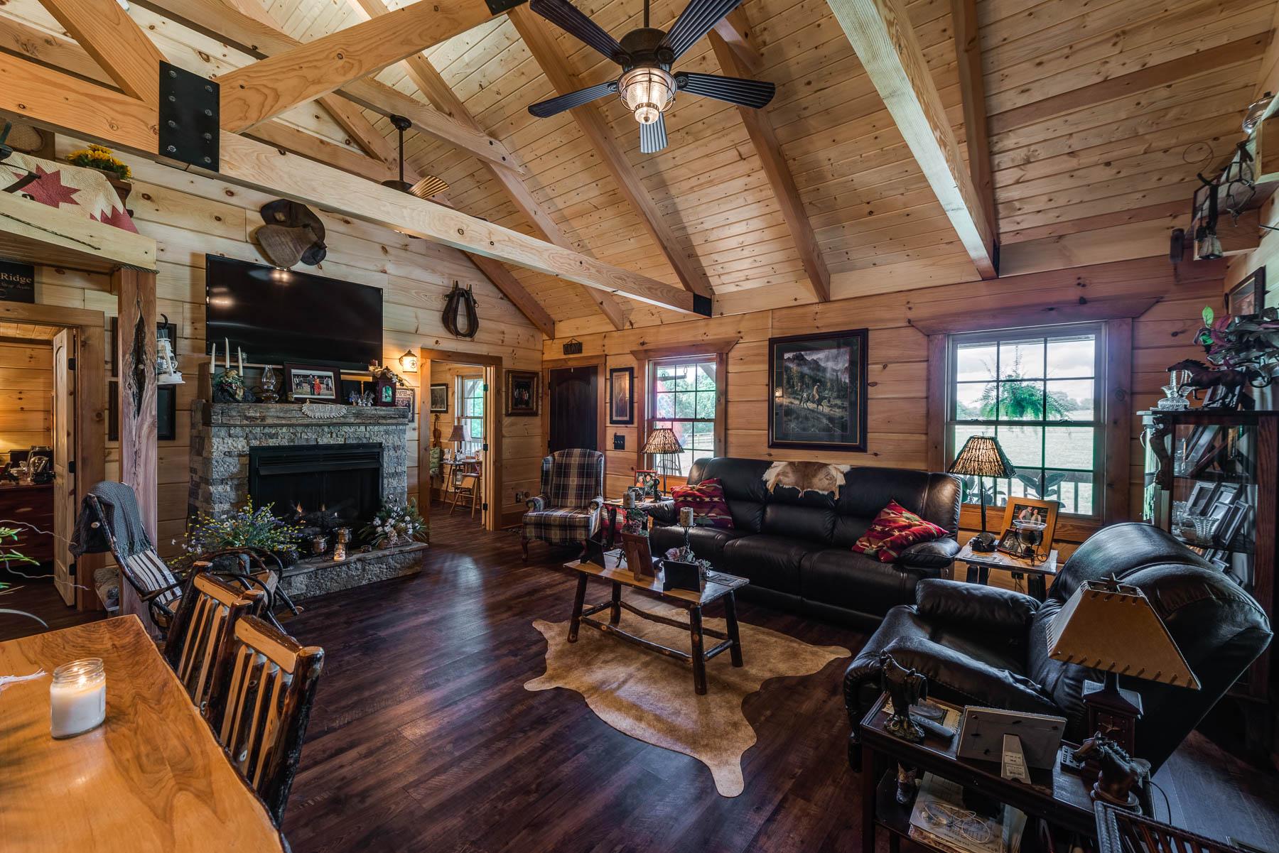 Clay Log Home Living Room with Heavy Timber Ceiling